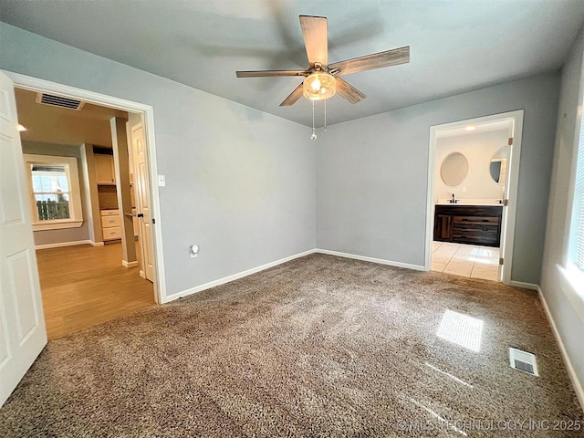 609 E Ward St, Tahlequah, OK 74464 - unfurnished bedroom featuring carpet, ensuite bathroom, and ceiling fan