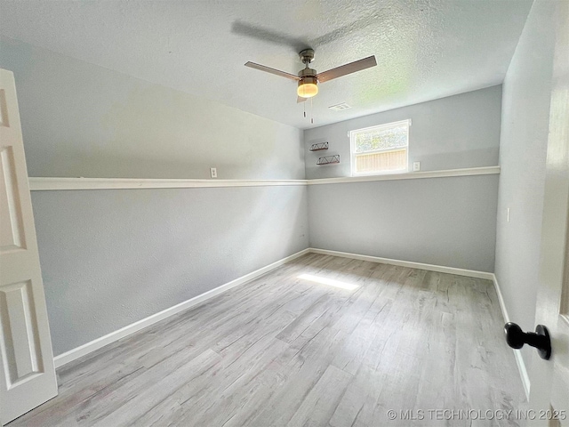 609 E Ward St, Tahlequah, OK 74464 - spare room featuring wood finished floors, ceiling fan, and a textured ceiling