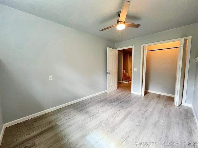 609 E Ward St, Tahlequah, OK 74464 - unfurnished bedroom with wood finished floors, a ceiling fan, and a closet