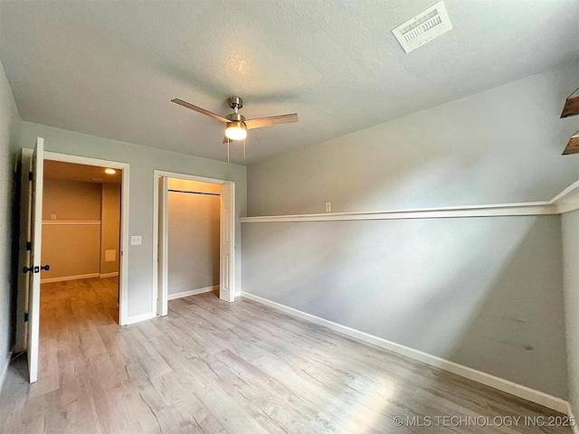 609 E Ward St, Tahlequah, OK 74464 - unfurnished bedroom with wood finished floors, a closet, a ceiling fan, and a textured ceiling