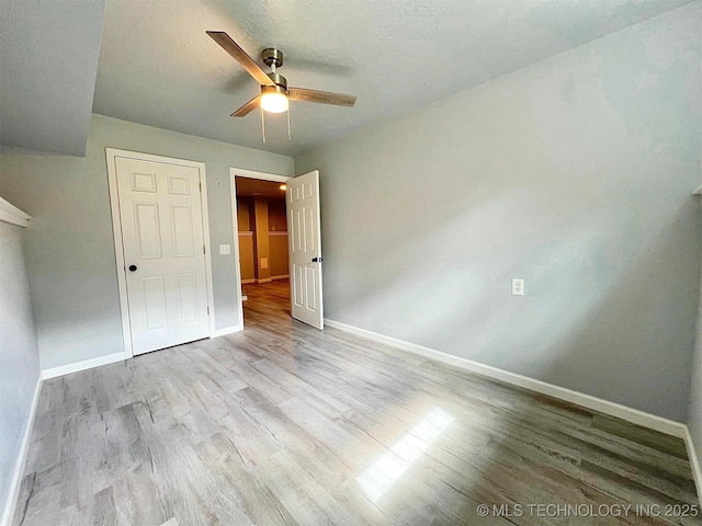 609 E Ward St, Tahlequah, OK 74464 - unfurnished bedroom with wood finished floors and ceiling fan