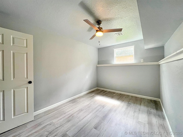 609 E Ward St, Tahlequah, OK 74464 - empty room featuring ceiling fan, wood finished floors, and a textured ceiling