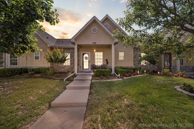 445 S Cypress Ave, Broken Arrow, OK 74012 - view of front of house featuring stone siding, stucco siding, and a front lawn