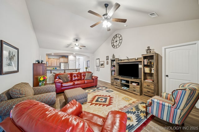 445 S Cypress Ave, Broken Arrow, OK 74012 - living area featuring lofted ceiling, a ceiling fan, wood finished floors, and arched walkways