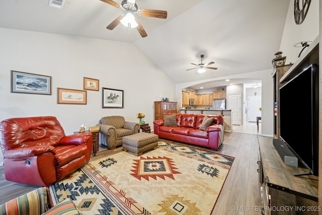 445 S Cypress Ave, Broken Arrow, OK 74012 - living room featuring a ceiling fan, hardwood / wood-style floors, vaulted ceiling, and arched walkways