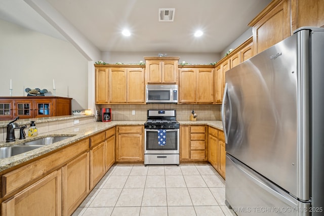 445 S Cypress Ave, Broken Arrow, OK 74012 - kitchen with appliances with stainless steel finishes, decorative backsplash, light stone counters, and recessed lighting