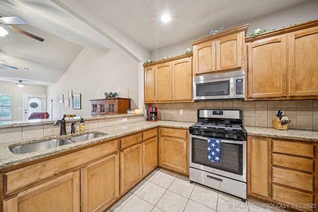 445 S Cypress Ave, Broken Arrow, OK 74012 - kitchen featuring appliances with stainless steel finishes, a ceiling fan, decorative backsplash, light tile patterned flooring, and light stone countertops
