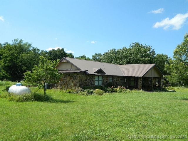 399987 W 3700th Rd, Ramona, OK 74061 - view of side of property with stone siding and a yard