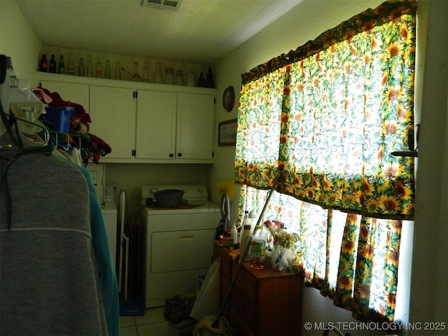 399987 W 3700th Rd, Ramona, OK 74061 - laundry area with washer / clothes dryer, cabinet space, and light tile patterned floors