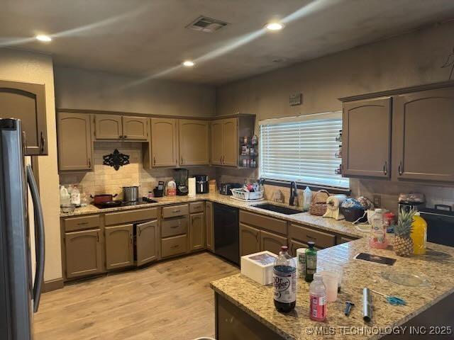 908 S Umbrella Cir, Broken Arrow, OK 74012 - kitchen featuring black appliances, light wood finished floors, light stone counters, tasteful backsplash, and recessed lighting