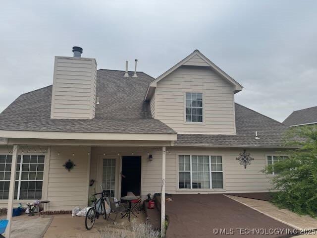 908 S Umbrella Cir, Broken Arrow, OK 74012 - back of property featuring a patio area, roof with shingles, and a chimney