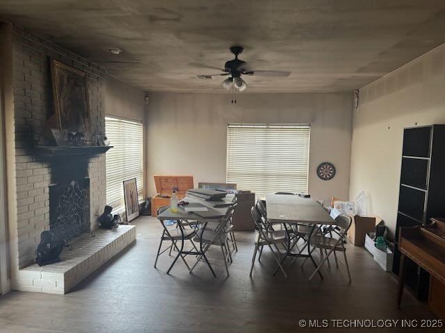 908 S Umbrella Cir, Broken Arrow, OK 74012 - dining space with ceiling fan, a brick fireplace, and wood finished floors