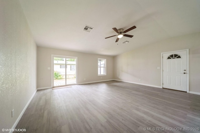 25530 S 608th Ct, Grove, OK 74344 - unfurnished living room featuring a ceiling fan, wood finished floors, and vaulted ceiling