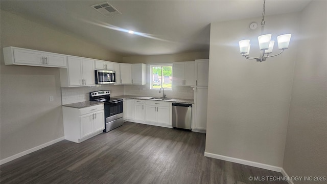25530 S 608th Ct, Grove, OK 74344 - kitchen with stainless steel appliances, tasteful backsplash, dark wood finished floors, white cabinetry, and vaulted ceiling