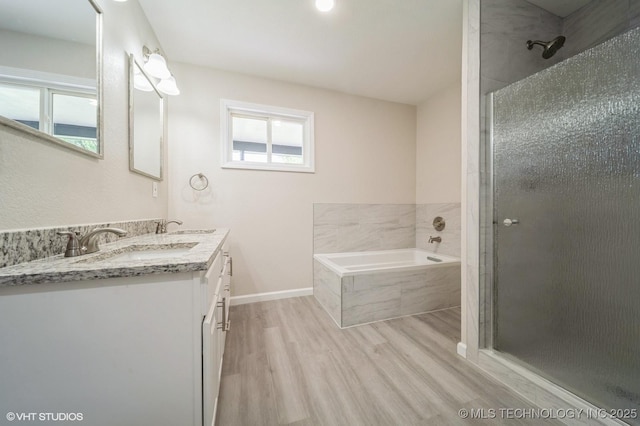 25530 S 608th Ct, Grove, OK 74344 - bathroom with wood finished floors, double vanity, a garden tub, and a stall shower