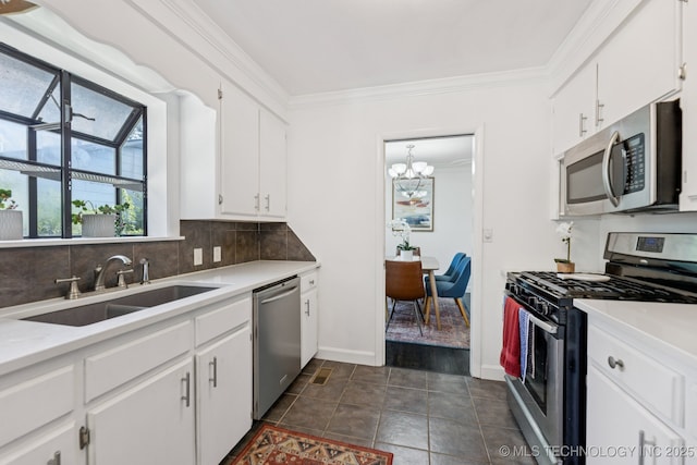 4019 E 37th St S, Tulsa, OK 74135 - kitchen with stainless steel appliances, a chandelier, tasteful backsplash, white cabinetry, and ornamental molding