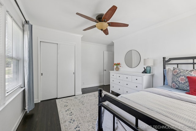 4019 E 37th St S, Tulsa, OK 74135 - bedroom featuring ornamental molding, dark wood-style floors, a ceiling fan, and a closet