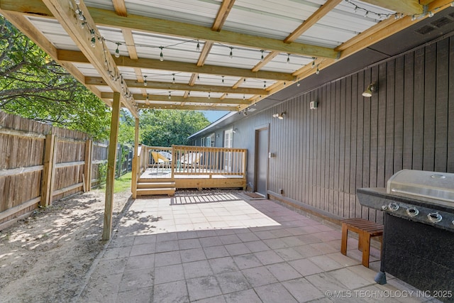 4019 E 37th St S, Tulsa, OK 74135 - fenced backyard featuring area for grilling, a wooden deck, and a patio area