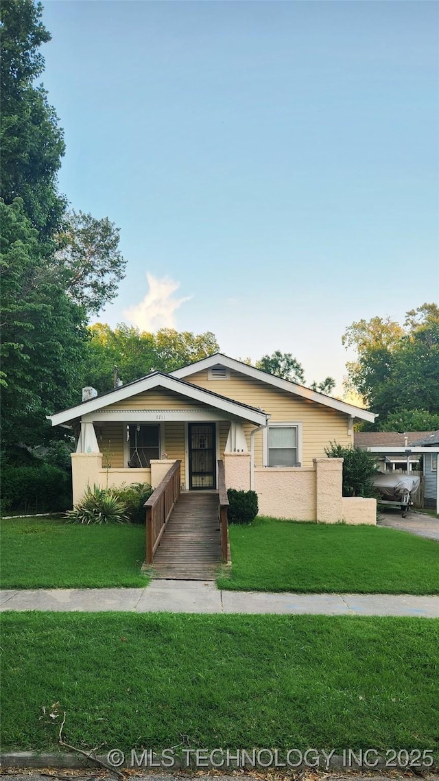 1711 S Saint Louis Ave, Tulsa, OK 74120 - view of front facade featuring a front lawn and a chimney