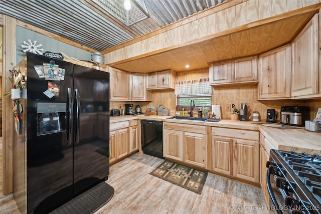 719 Oklahoma Ave, Wynona, OK 74084 - kitchen with refrigerator with ice dispenser, black dishwasher, light countertops, light brown cabinets, and gas range oven