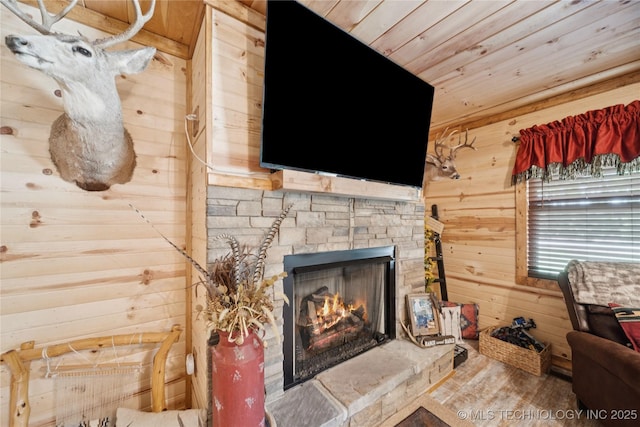 719 Oklahoma Ave, Wynona, OK 74084 - detailed view of wooden ceiling, wood walls, a fireplace, and wood finished floors