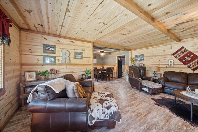 719 Oklahoma Ave, Wynona, OK 74084 - living area with wooden walls, wood ceiling, wood finished floors, and ceiling fan