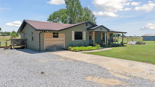 719 Oklahoma Ave, Wynona, OK 74084 - view of front of property featuring brick siding, a front yard, covered porch, and driveway