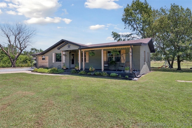 719 Oklahoma Ave, Wynona, OK 74084 - view of front of house with a porch, brick siding, and a front yard