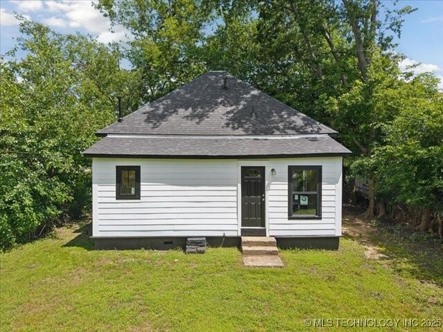 409 N Cherokee St, Claremore, OK 74017 - back of property with a yard, roof with shingles, and entry steps