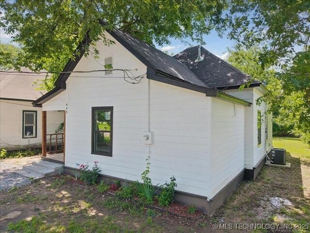 409 N Cherokee St, Claremore, OK 74017 - view of home's exterior featuring a shingled roof and a central air condition unit