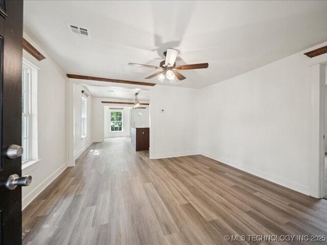 409 N Cherokee St, Claremore, OK 74017 - unfurnished living room featuring wood finished floors and a ceiling fan