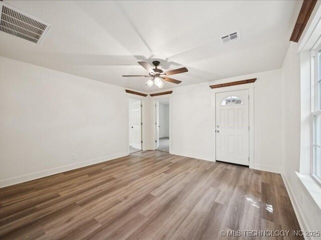 409 N Cherokee St, Claremore, OK 74017 - empty room with ceiling fan and wood finished floors