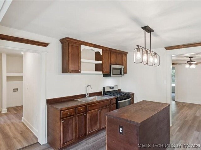 409 N Cherokee St, Claremore, OK 74017 - kitchen with appliances with stainless steel finishes, open shelves, wood finished floors, and ceiling fan