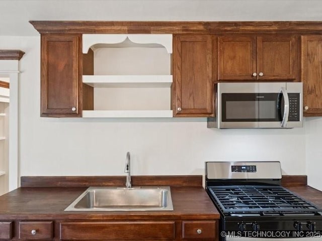 409 N Cherokee St, Claremore, OK 74017 - kitchen with stainless steel appliances, open shelves, and dark countertops