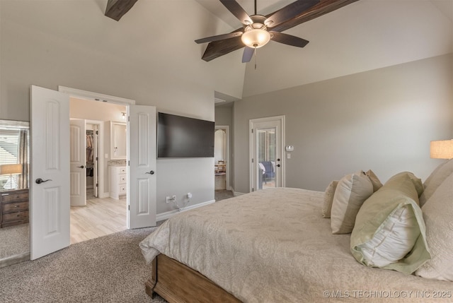 449 E 129th Pl, Jenks, OK 74037 - bedroom with light colored carpet, high vaulted ceiling, a walk in closet, a ceiling fan, and ensuite bath