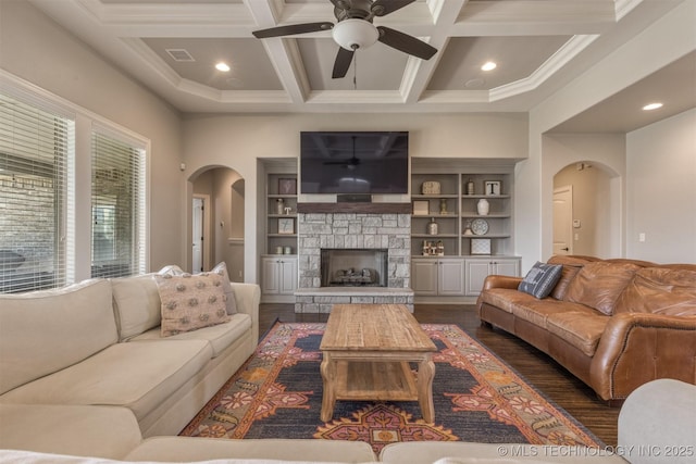 449 E 129th Pl, Jenks, OK 74037 - living room featuring arched walkways, ceiling fan, coffered ceiling, dark wood finished floors, and a fireplace