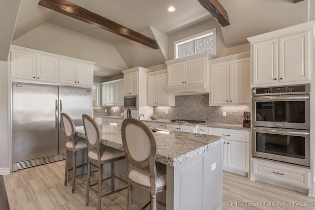 449 E 129th Pl, Jenks, OK 74037 - kitchen featuring appliances with stainless steel finishes, decorative backsplash, white cabinets, light stone counters, and recessed lighting