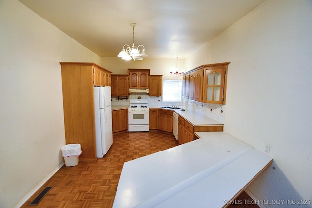 16759 W Burchett Rd, Tahlequah, OK 74464 - kitchen featuring white appliances, a chandelier, tasteful backsplash, under cabinet range hood, and brown cabinets