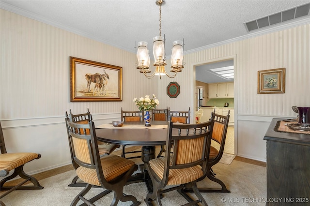 7033 E 99th St, Tulsa, OK 74133 - dining room featuring ornamental molding, light carpet, wainscoting, a chandelier, and wallpapered walls