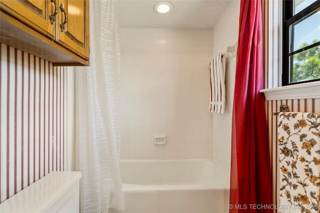 7033 E 99th St, Tulsa, OK 74133 - bathroom with shower / bath combo and a textured ceiling