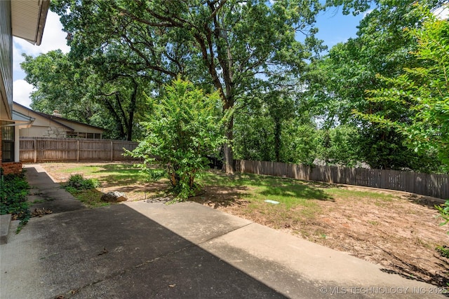 7033 E 99th St, Tulsa, OK 74133 - fenced backyard featuring a patio area