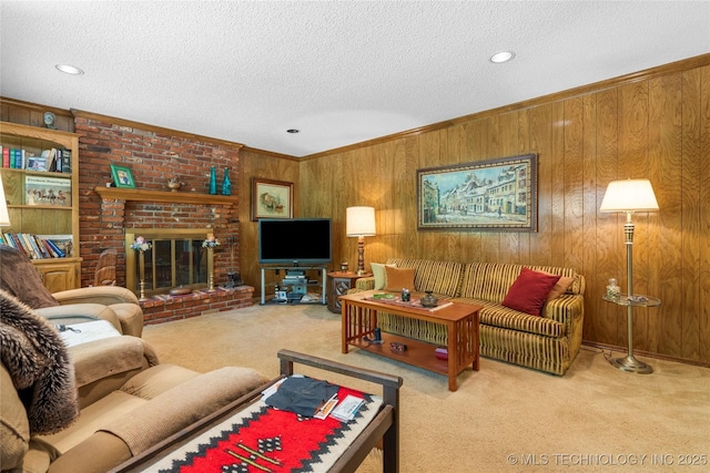 7033 E 99th St, Tulsa, OK 74133 - carpeted living area featuring wood walls, a textured ceiling, crown molding, a fireplace, and recessed lighting