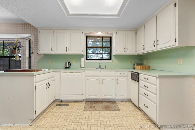 7033 E 99th St, Tulsa, OK 74133 - kitchen with dishwasher, white cabinets, light countertops, a textured ceiling, and a peninsula