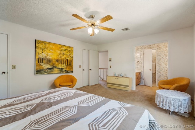 7033 E 99th St, Tulsa, OK 74133 - carpeted bedroom with connected bathroom and ceiling fan