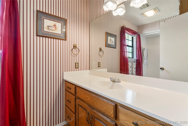 7033 E 99th St, Tulsa, OK 74133 - bathroom featuring wallpapered walls and vanity