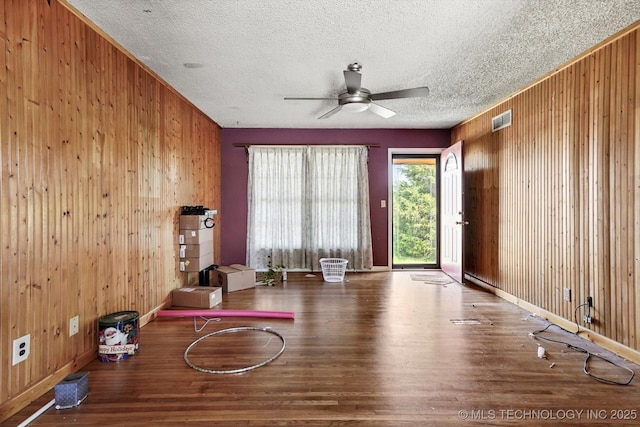 705 W Hartford Pl, Broken Arrow, OK 74012 - interior space with wood walls, wood finished floors, a ceiling fan, and a textured ceiling