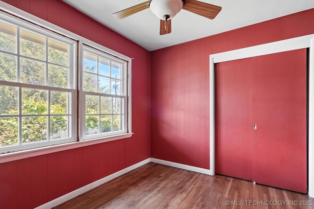 705 W Hartford Pl, Broken Arrow, OK 74012 - unfurnished bedroom with wood finished floors, ceiling fan, and a closet