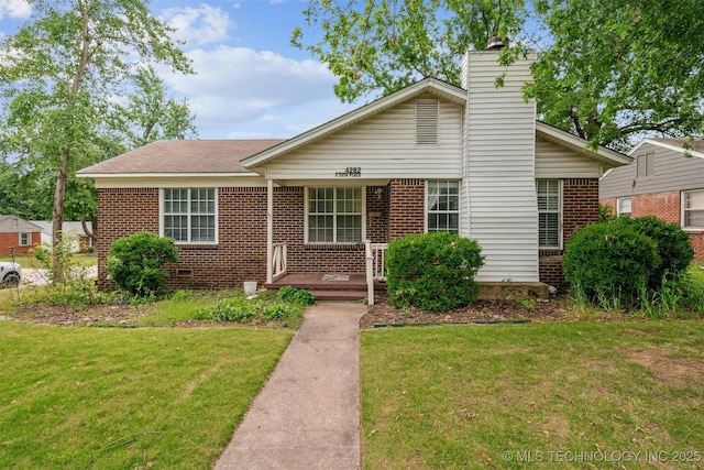 4262 E 24th Pl, Tulsa, OK 74114 - view of front of home featuring brick siding, a front yard, and a chimney