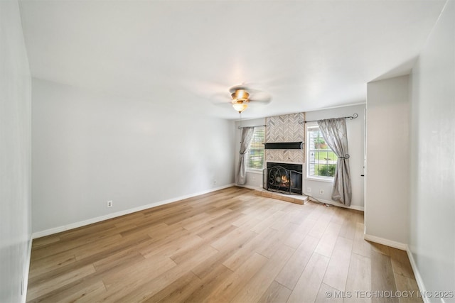 4262 E 24th Pl, Tulsa, OK 74114 - unfurnished living room featuring light wood finished floors, a fireplace, and a ceiling fan