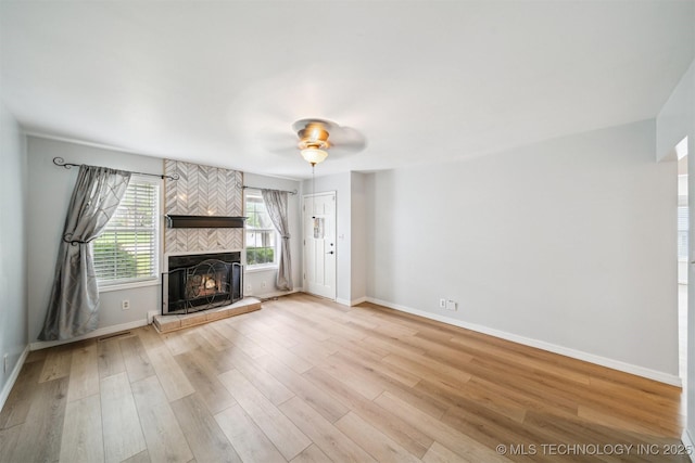 4262 E 24th Pl, Tulsa, OK 74114 - unfurnished living room featuring light wood-style floors, a fireplace, and a ceiling fan